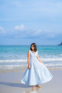 Woman on beach against sky