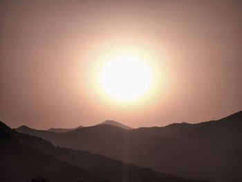 Scenic view of silhouette mountains against sky during sunset