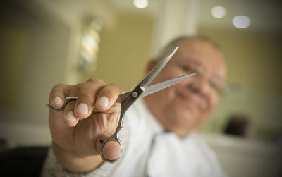 Close-up portrait of man holding hands