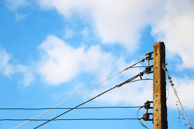 Low angle view of electricity pylon against sky