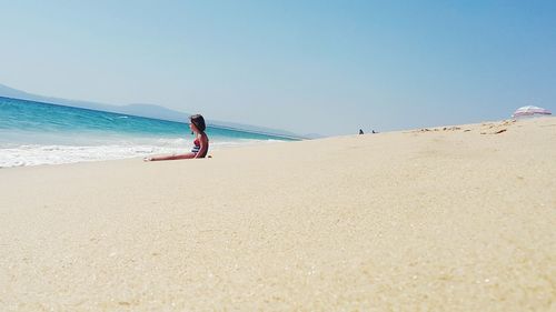Scenic view of beach against blue sky