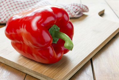 Close-up of red chili peppers on cutting board