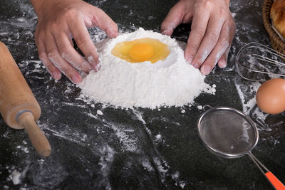 Midsection of man preparing food in kitchen