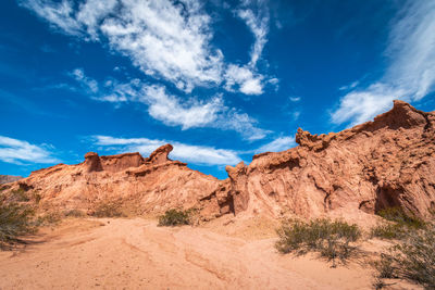 Scenic view of rocky mountains against blue sky