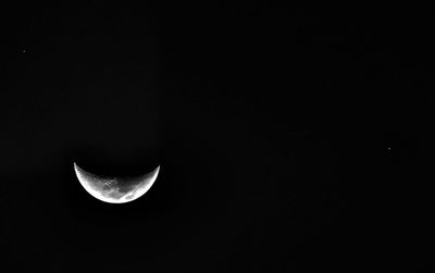 Low angle view of half moon against sky at night