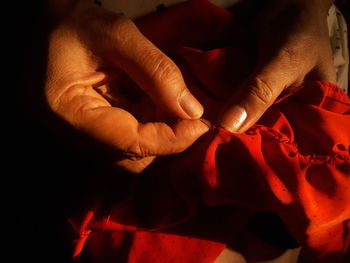 Close-up of man holding red rose