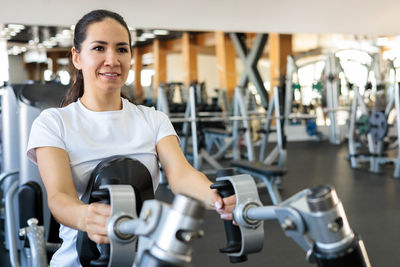 Portrait of young man exercising in gym