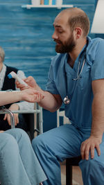 Side view of doctor examining patient at harbor