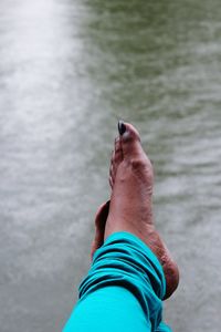 Low section of woman relaxing in water