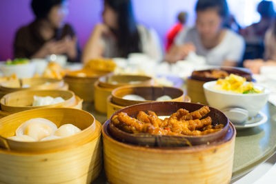 Food in container on table with people in background at restaurant