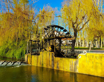 Yellow bridge over river during autumn
