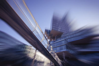 Low angle view of bridge and buildings against sky