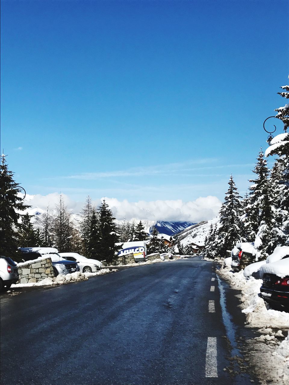 tree, snow, blue, cold temperature, transportation, clear sky, winter, the way forward, day, road, no people, nature, sky, outdoors, beauty in nature, scenics