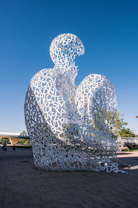 Statue against blue sky in city