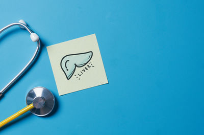 Directly above shot of stethoscope on blue background