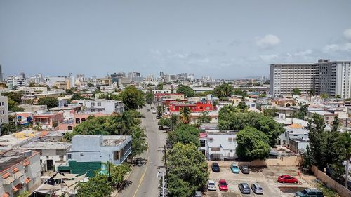 High angle view of trees and buildings against sky