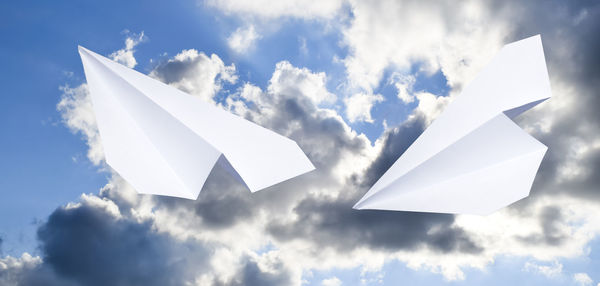 Low angle view of paper flying in sky