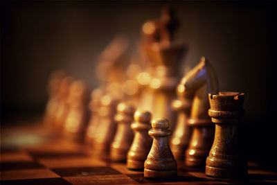 Close-up of wooden chess pieces on board