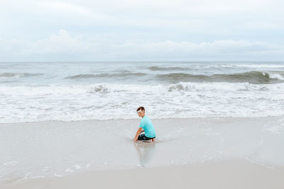 Full length of man on beach against sky