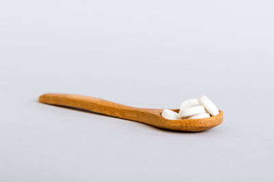 High angle view of pills against white background