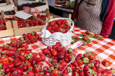 Strawberry season. female farmer selling organic and fresh strawberries at the market.