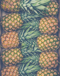 Retro style background texture of fresh pineapples at a market stall