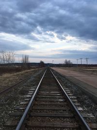 View of railway tracks against cloudy sky