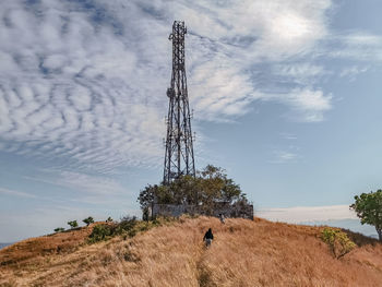 Low angle view of man on field against sky