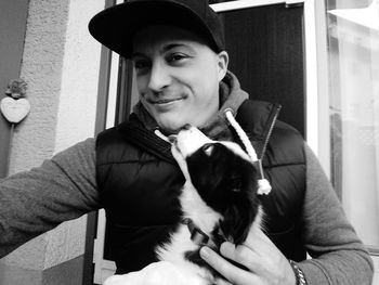 Portrait of young woman holding dog