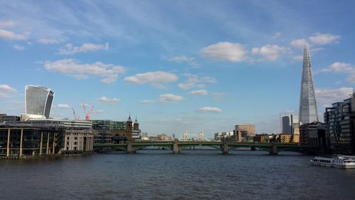 Bridge over river with city in background