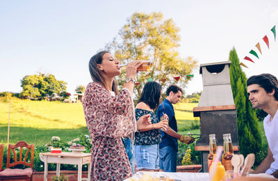 Friends having leisure time together at backyard