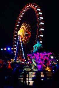 Low angle view of ferris wheel at night