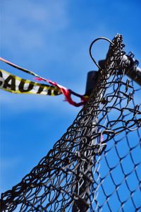 Low angle view of decoration hanging against blue sky