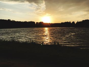View of lake against cloudy sky during sunset