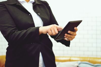 Midsection of man using mobile phone