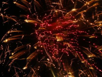 Low angle view of firework display at night