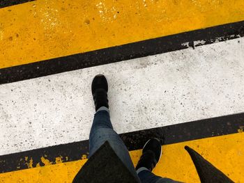 Low section of person standing on road