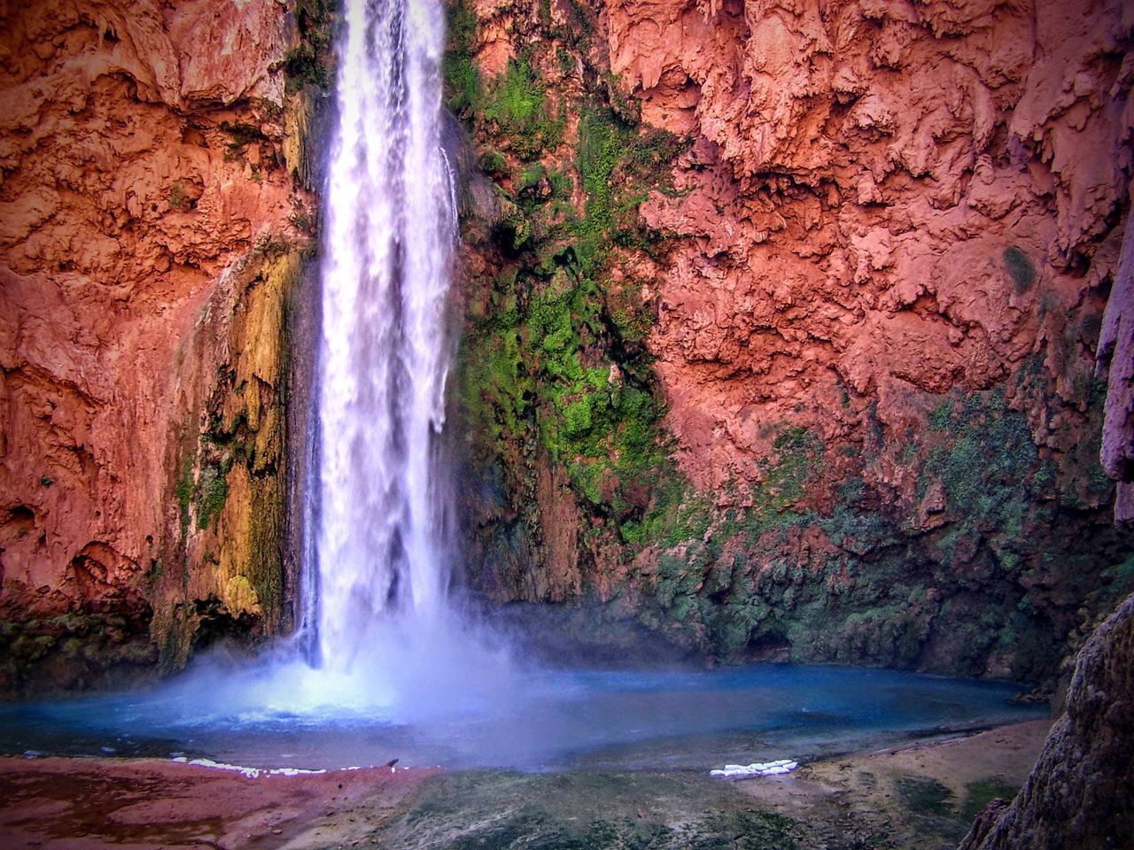 SCENIC VIEW OF WATERFALL AGAINST ROCK FORMATION