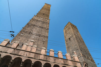 Low angle view of historic buildings against clear blue sky