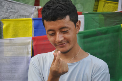 Side view of young man using mobile phone