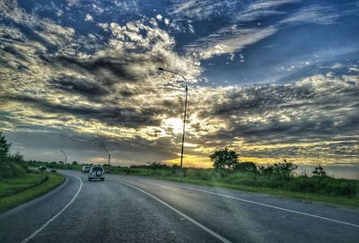 Road against dramatic sky during sunset