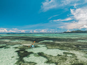 Man on shore against sky