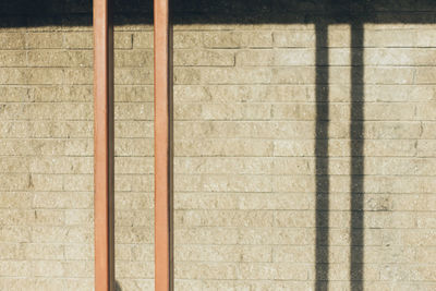 Shadow of metals on brick wall