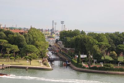 Scenic view of river by trees against sky