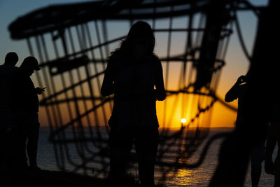 Silhouette of group of people against the sunset. 