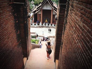 Rear view of people walking on steps