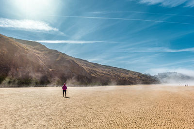 Woman standing at saltburn-by-the-sea against sky