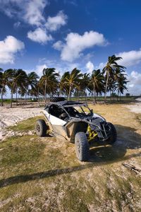 Close-up of car on field against sky