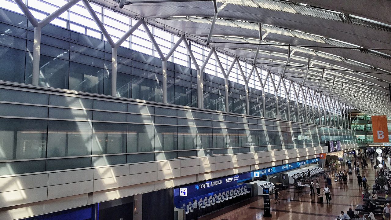 architecture, built structure, modern, building exterior, indoors, glass - material, city, building, reflection, transportation, incidental people, ceiling, low angle view, bridge - man made structure, railroad station, railing, city life, travel, day, travel destinations