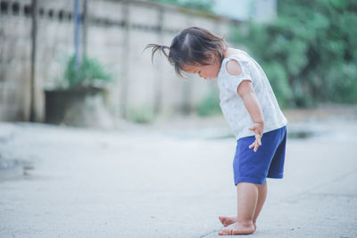 Cute girl standing on road